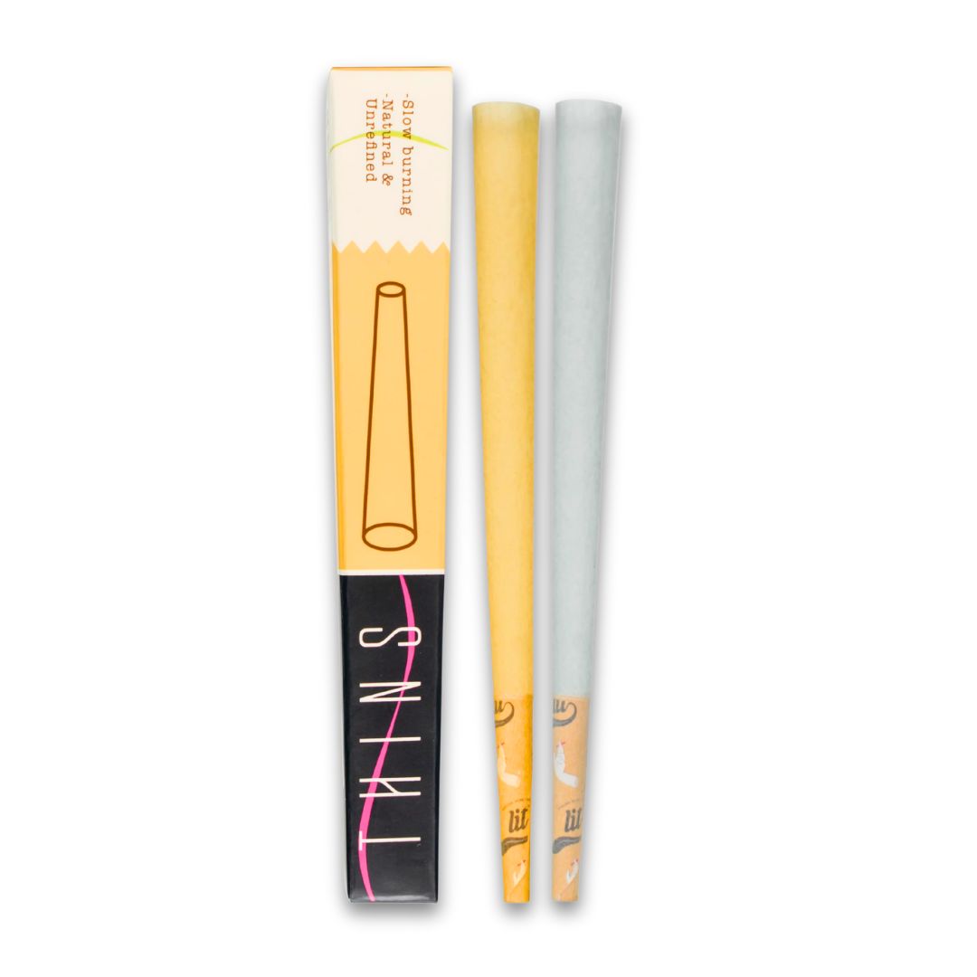 Two lip liners, one yellow and one gray, with their packaging on a white background.